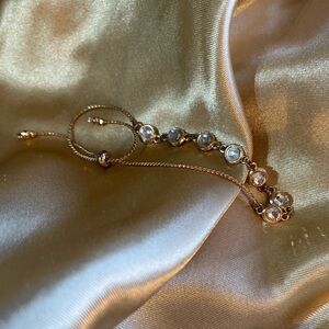 Goldtone Dainty Bracelet with Enclosed Crystals & Bangle Tie
Closure